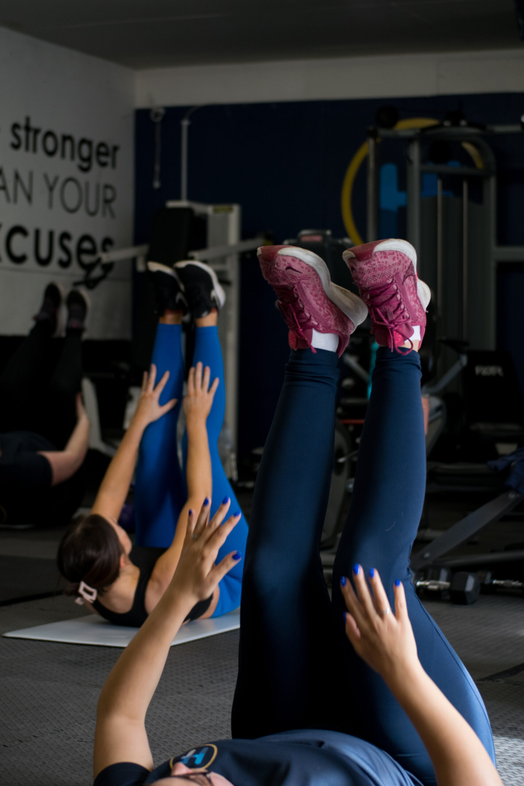 Women doing leg raises during a gym class